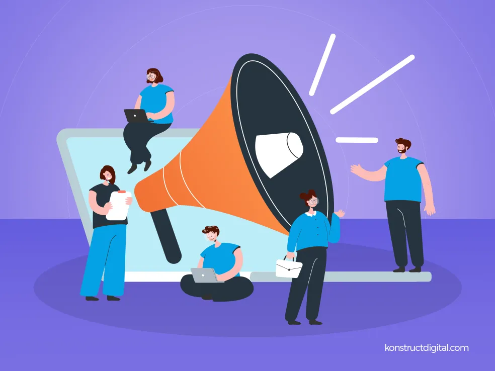 A group of people creating content, a laptop, and a megaphone