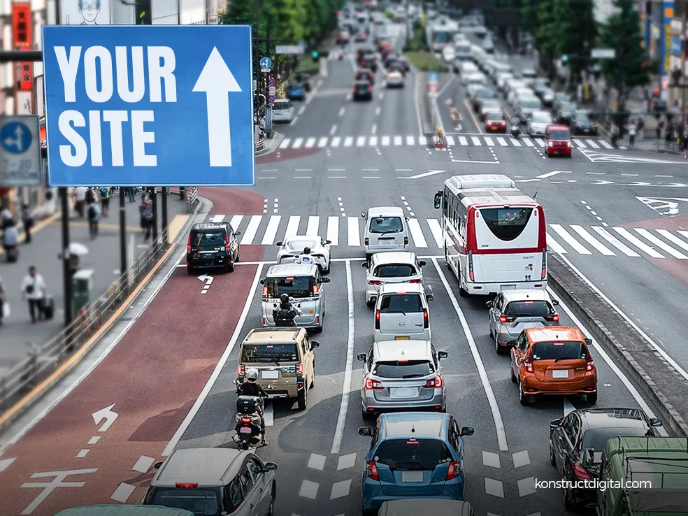 Traffic in a busy street with a sign saying “Your Site”, with an arrow pointing up.