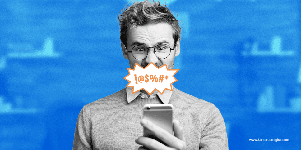 A man looking at his phone and swearing