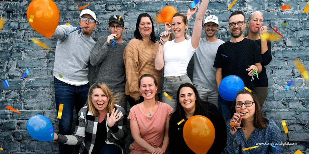 A banner image with the Konstruct team celebrating.