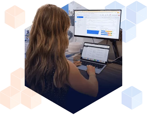 A marketer reviews Google Ads campaign performance dashboards, tracking qualified pipeline and conversion data.
