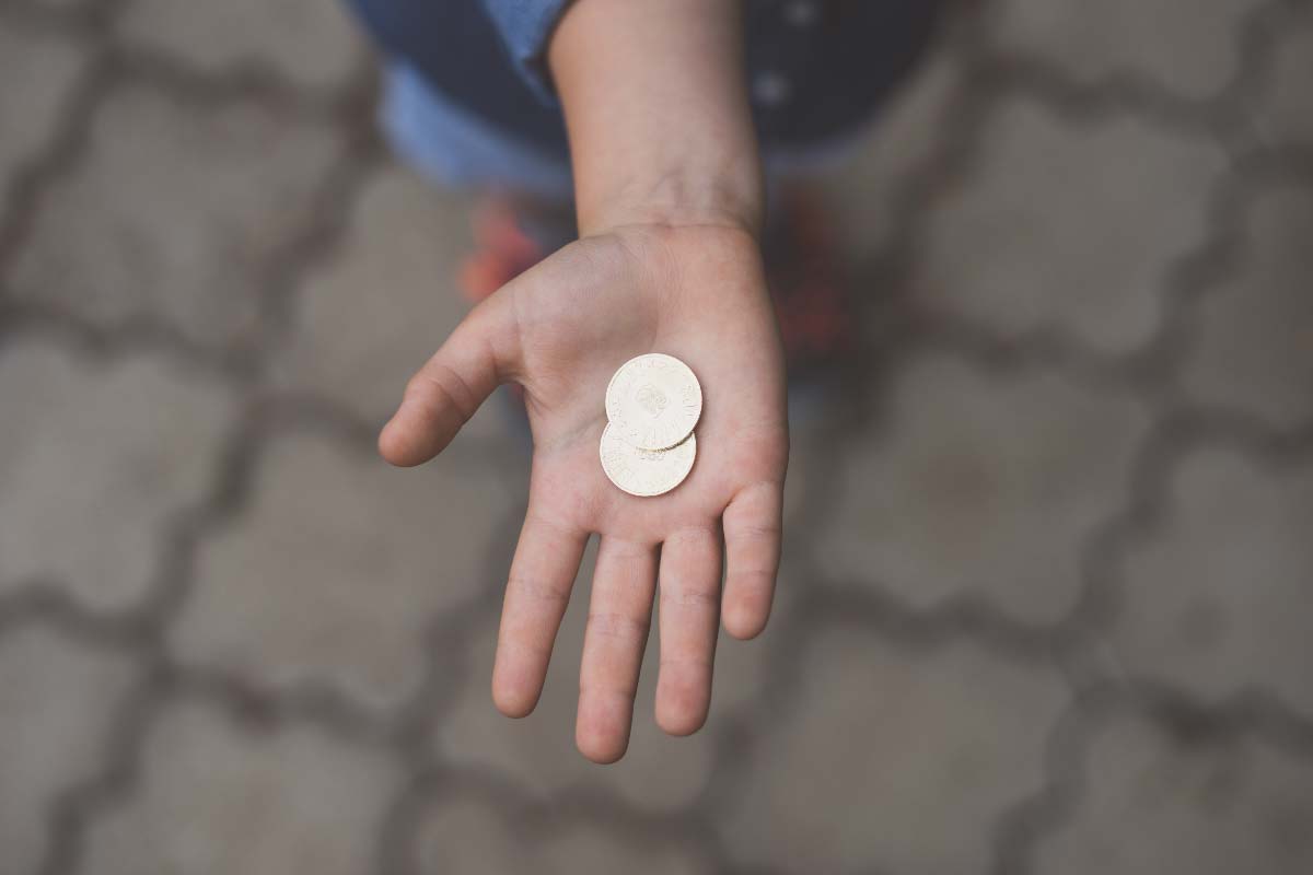 Coins in the palm of a person's hand