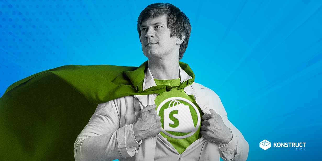 A man wearing a Shopify shirt and a cape.