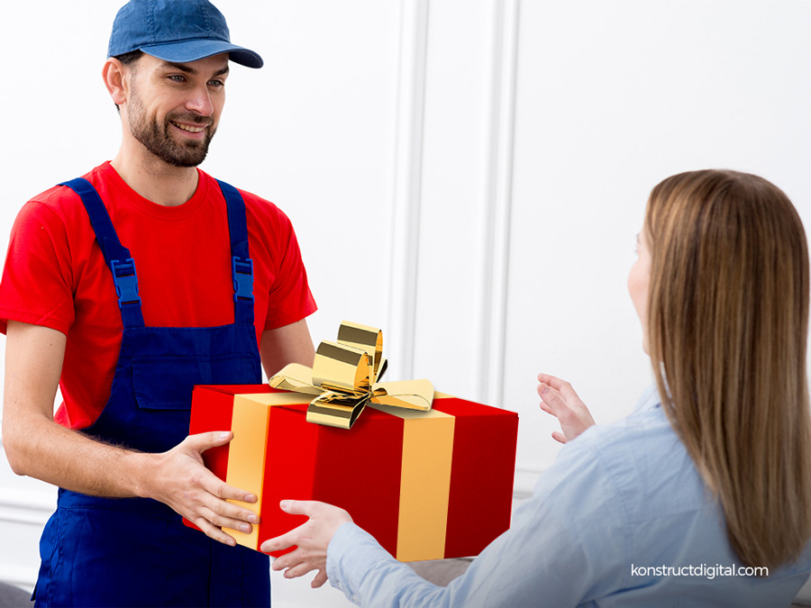 A mailman handing a gift to a woman