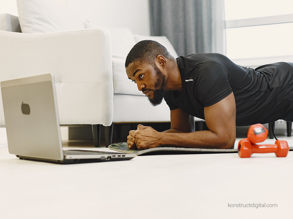 A man taking an online fitness class