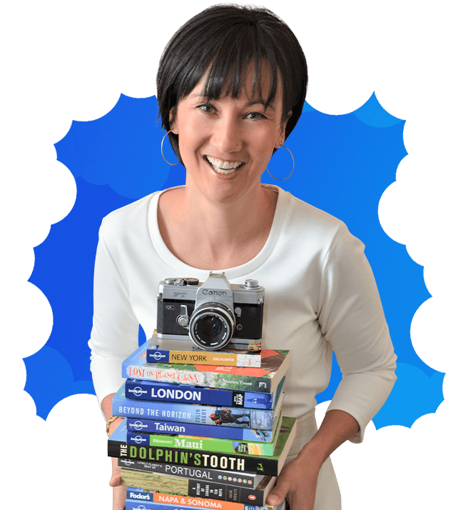 Denise Ebata smiling with her books and camera