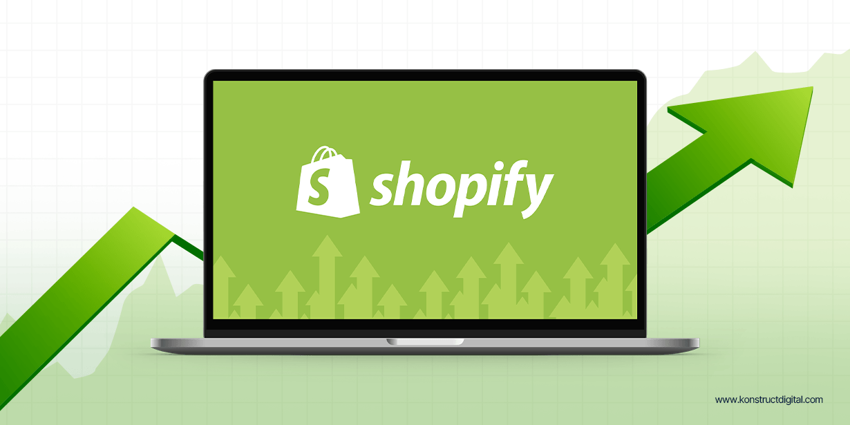 A computer with the Shopify logo on the screen and a large green arrow pointing up.