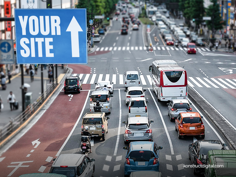 Traffic in a busy street with a sign saying “Your Site”, with an arrow pointing up. 