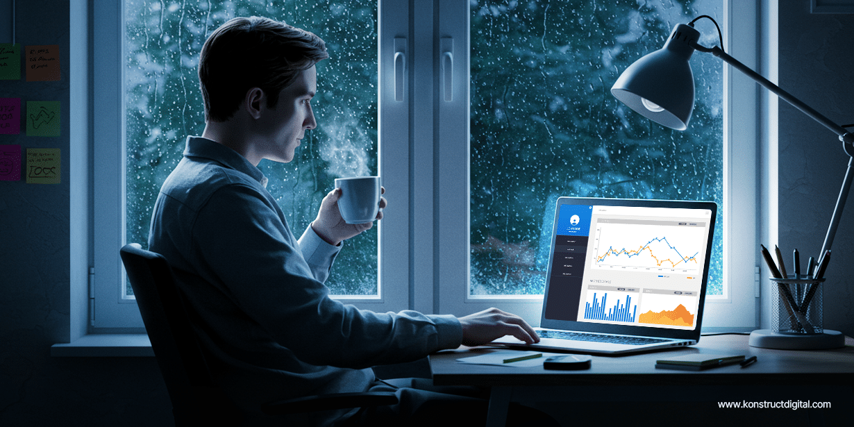 Person analyzing SEO performance charts on a laptop while drinking coffee by a rainy window.
